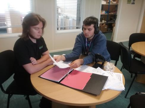 James with his carer Tom, filing some supplier invoices James with his carer Tom, filing some supplier invoices
